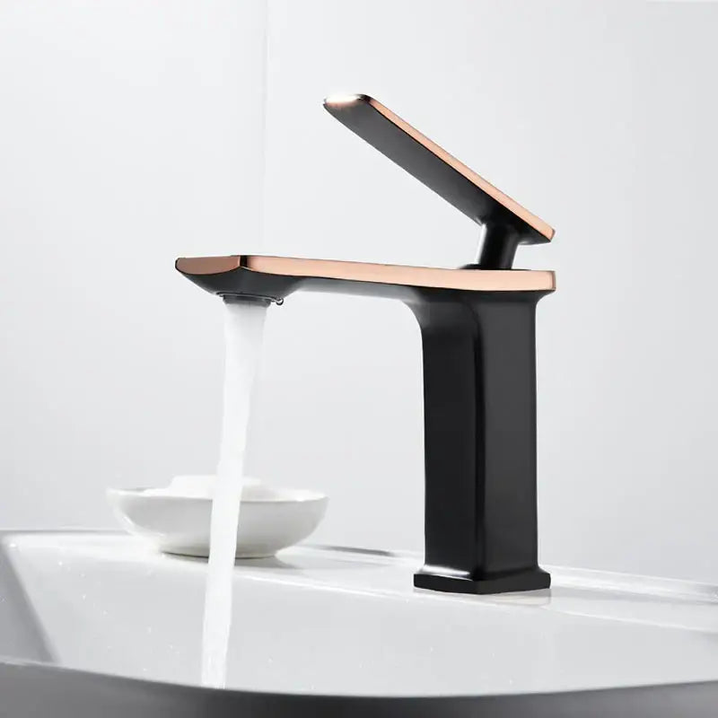Modern gold rectangular brass basin faucet with a two-tone black base and rose gold decorbites brass basin accents