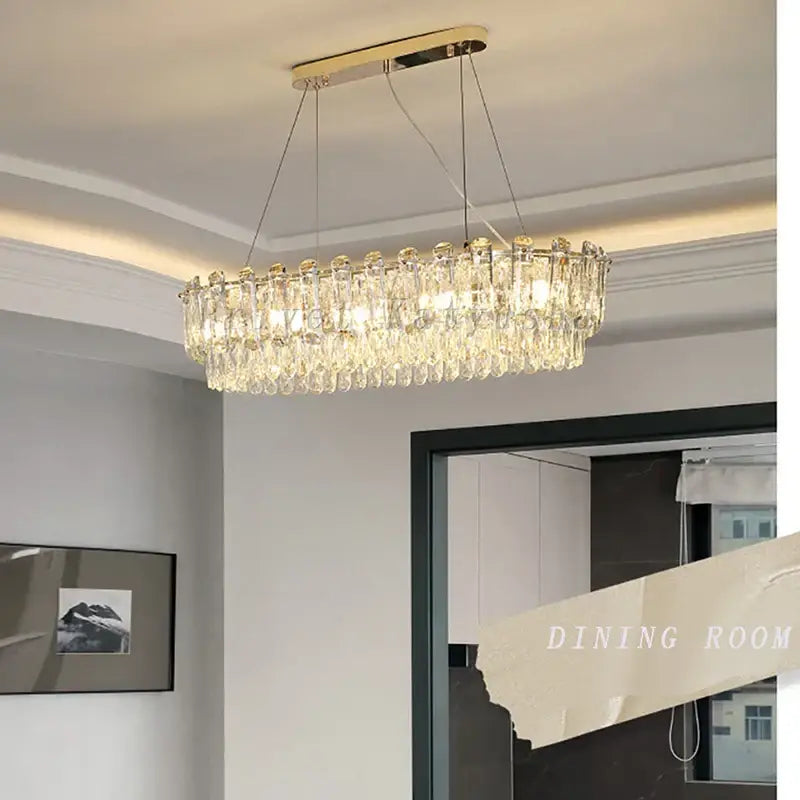 Modern gold rectangular crystal pendant chandelier with metal frame and cascading clear droplets for dining room decorbites crystal pendant