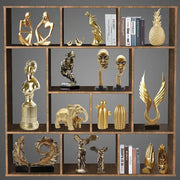 Modern gold resin sculpture living room abstract figurine featuring decorbites gold resin figurines on wooden shelf