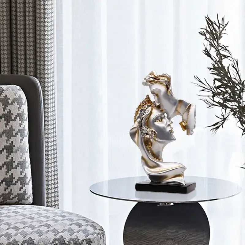 Modern gold resin sculpture featuring silver and gold intertwined female busts on black base by decorbites gold resin