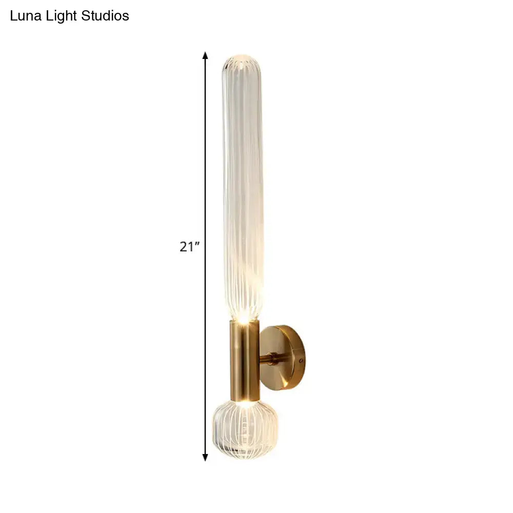 Modern gold wall lighting fixture with 21 inch ribbed glass tube and faceted crystal base for bedroom use
