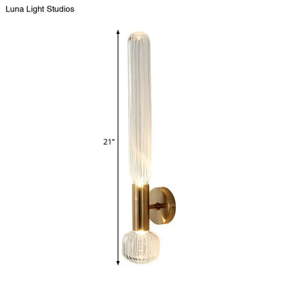 Modern gold wall lighting fixture with 21 inch ribbed glass tube and faceted crystal base for bedroom use