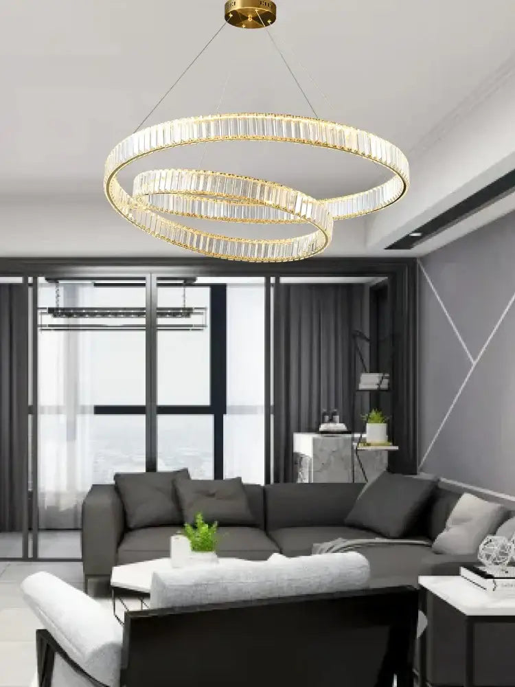Modern gold ring crystal led pendant light with three interlocking circular rings for living room decorbites crystal led chandelier
