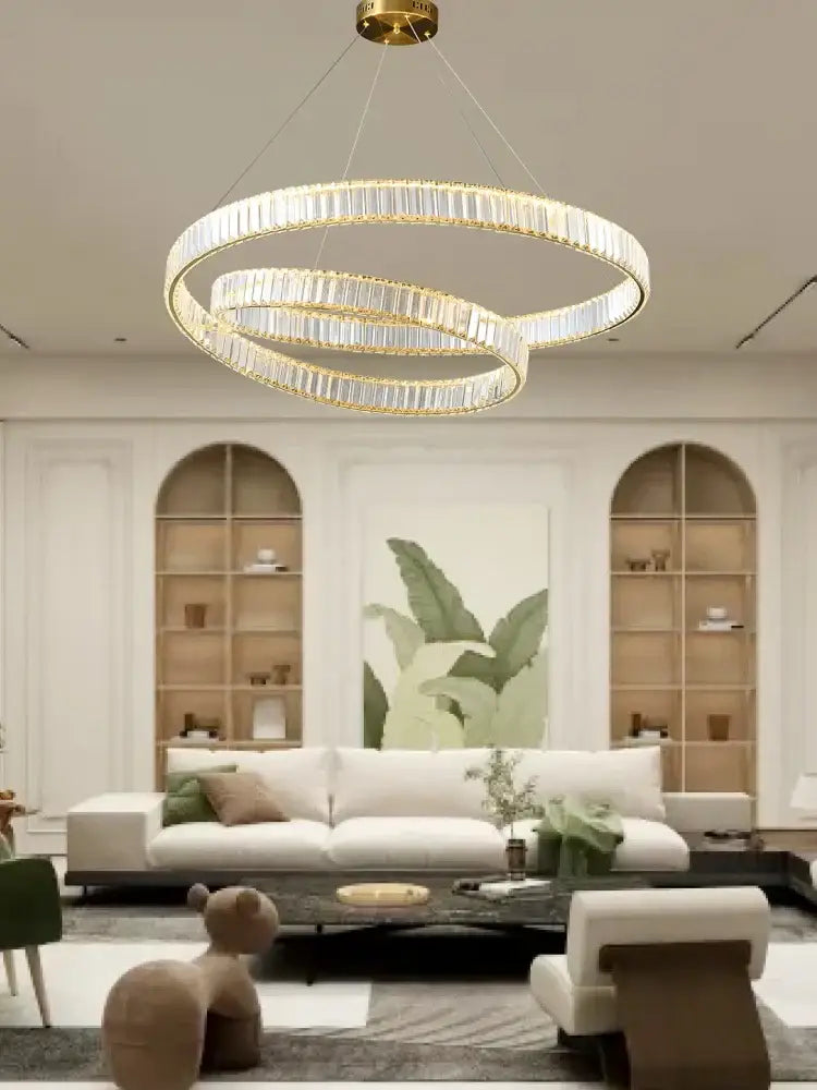 Modern gold ring crystal led pendant light with three interlocking circular rings for living room decorbites crystal led chandelier