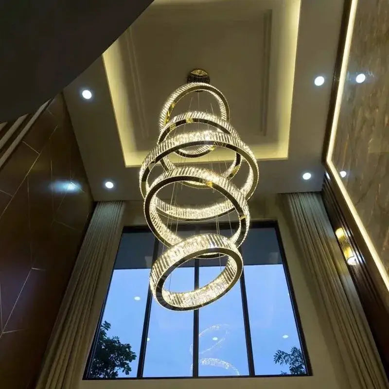 A modern gold decorbites crystal led chandelier with spiral rings encrusted in clear crystals for living room lighting