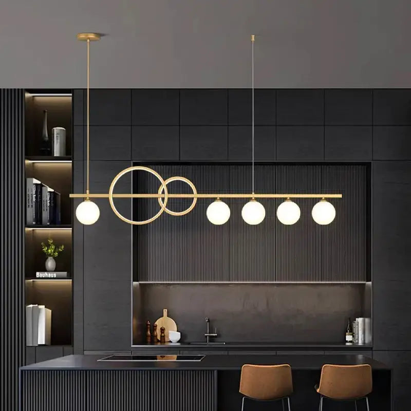 Modern gold pendant light with sleek horizontal bar, intersecting rings, and five frosted glass bulbs for elegant chandelier dining