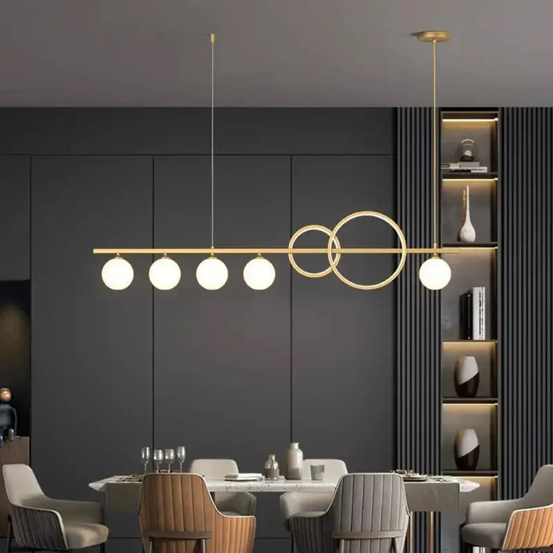 Modern gold-toned pendant light with five frosted glass bulbs and abstract metal design decorbites elegant chandelier dining