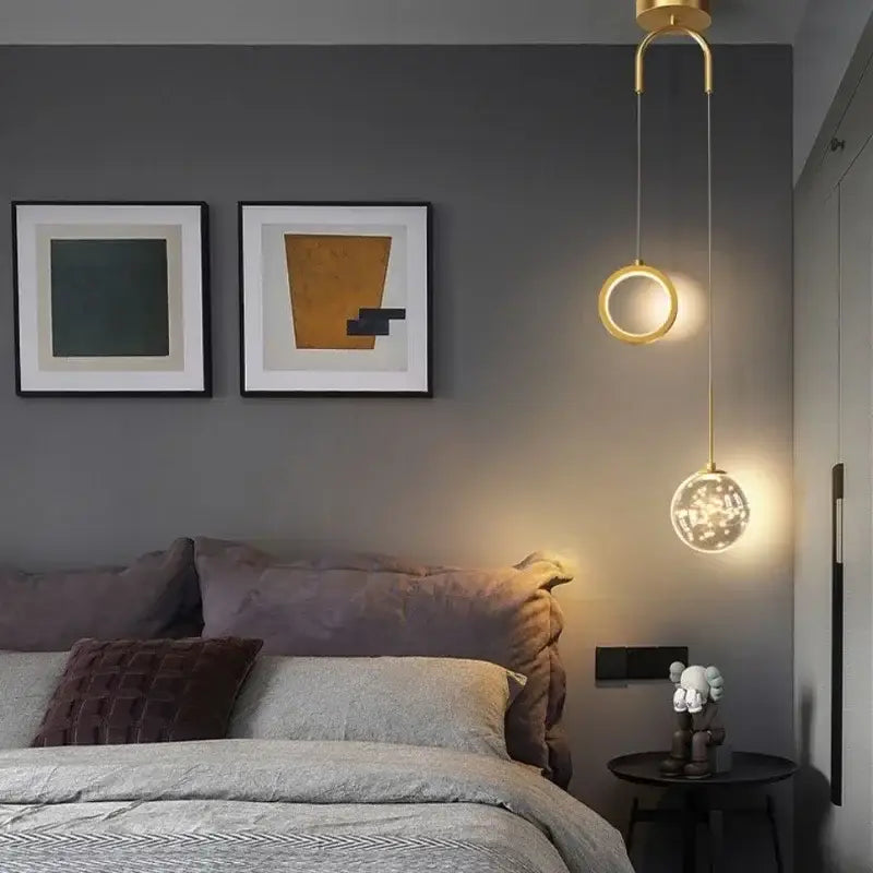 Modern gold ring led pendant light with crystal spherical globe in gold tone hanging above bed for decorbites decor