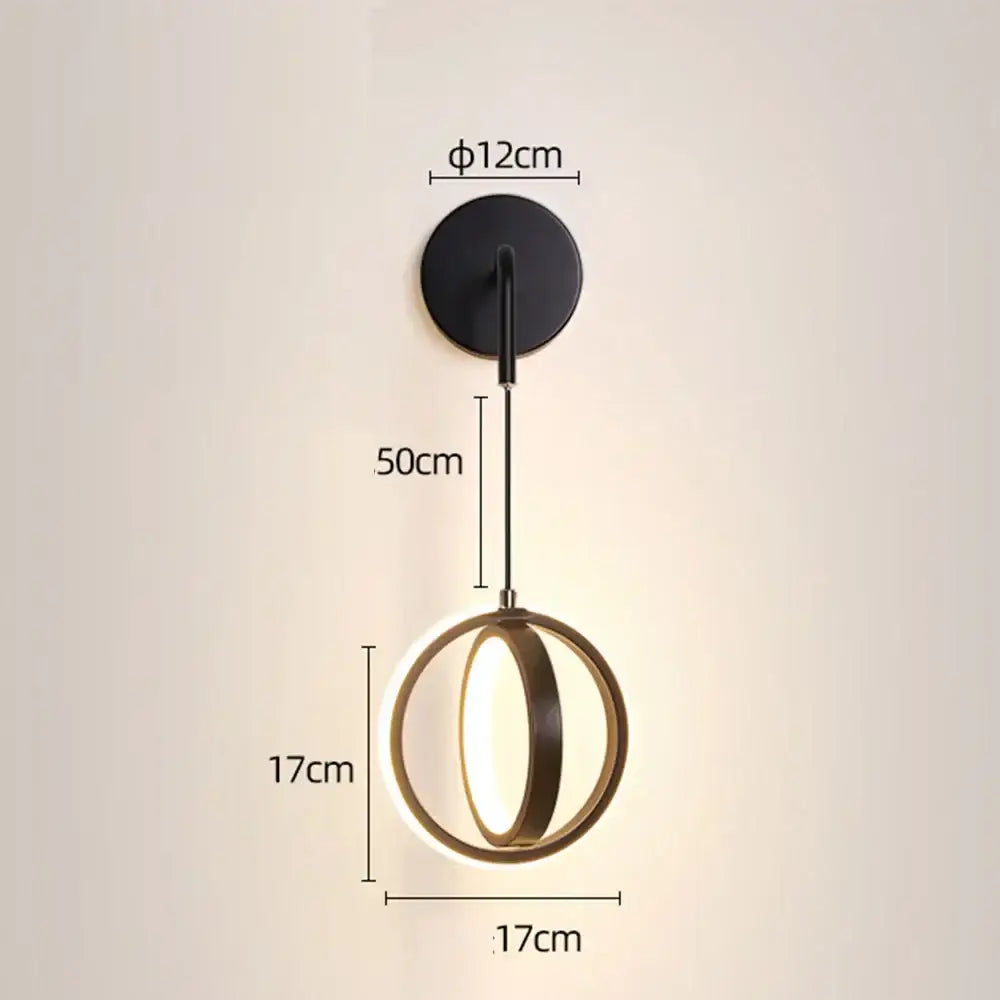 Modern gold ring led wall lamp with black circular frame and two gold-toned rings illuminating a sleek led wall light