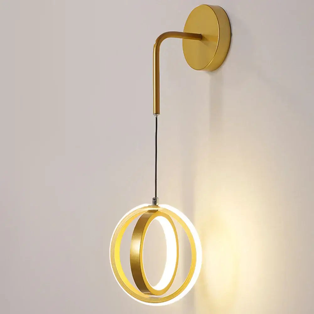 Modern gold ring led wall lamp with two concentric circular rings emitting warm glow for bedroom and living room
