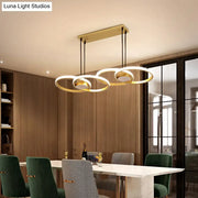 Modern gold ring pendant light with three interlocking circular rings and warm white led for kitchen use