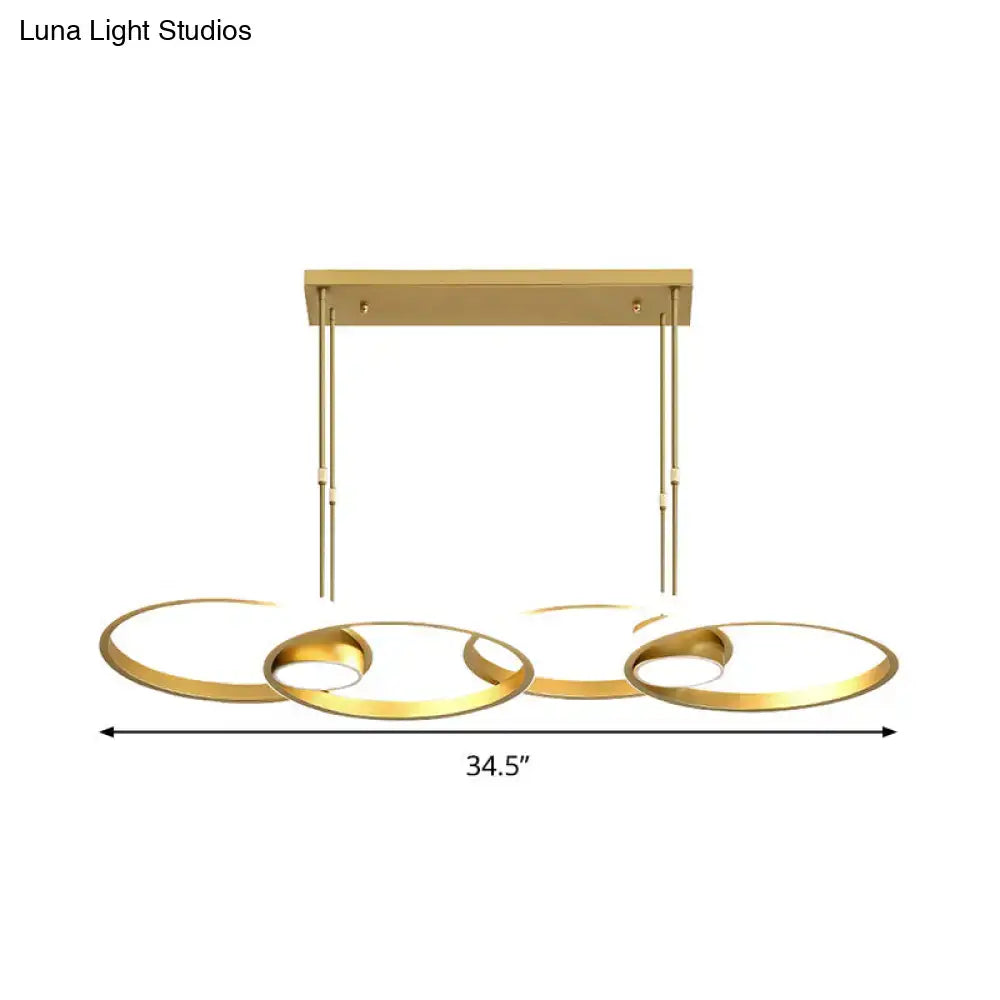 Modern gold pendant light with three interconnected circular rings and warm white led for kitchen lighting