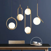 Modern gold ring pendant light with frosted glass spheres and minimalist geometric frame pendant light for living room