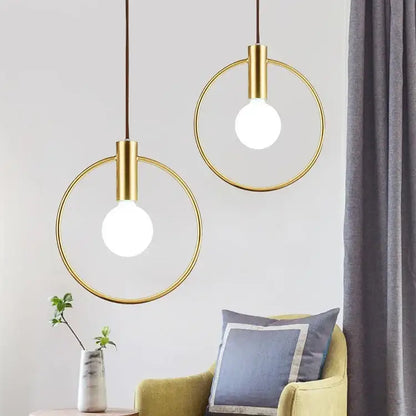 Two modern gold-toned decorbites gold ring pendant light fixtures with exposed bulbs for living room decor