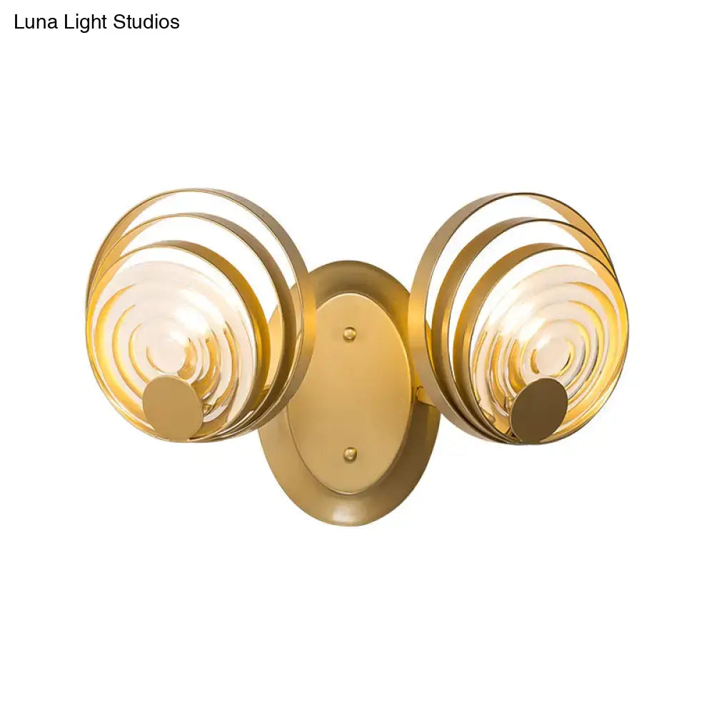 Modern gold ripple glass wall light fixture with two circular concentric glass shades for living room use