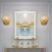 Modern gold ripple glass wall light fixture featuring gold-toned concentric circles for living room use
