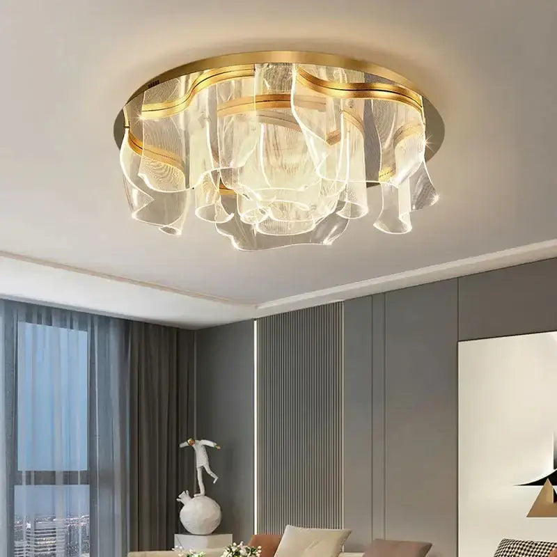 Modern gold led ceiling chandelier with layered translucent glass shades in a ripple design for luxury dining rooms
