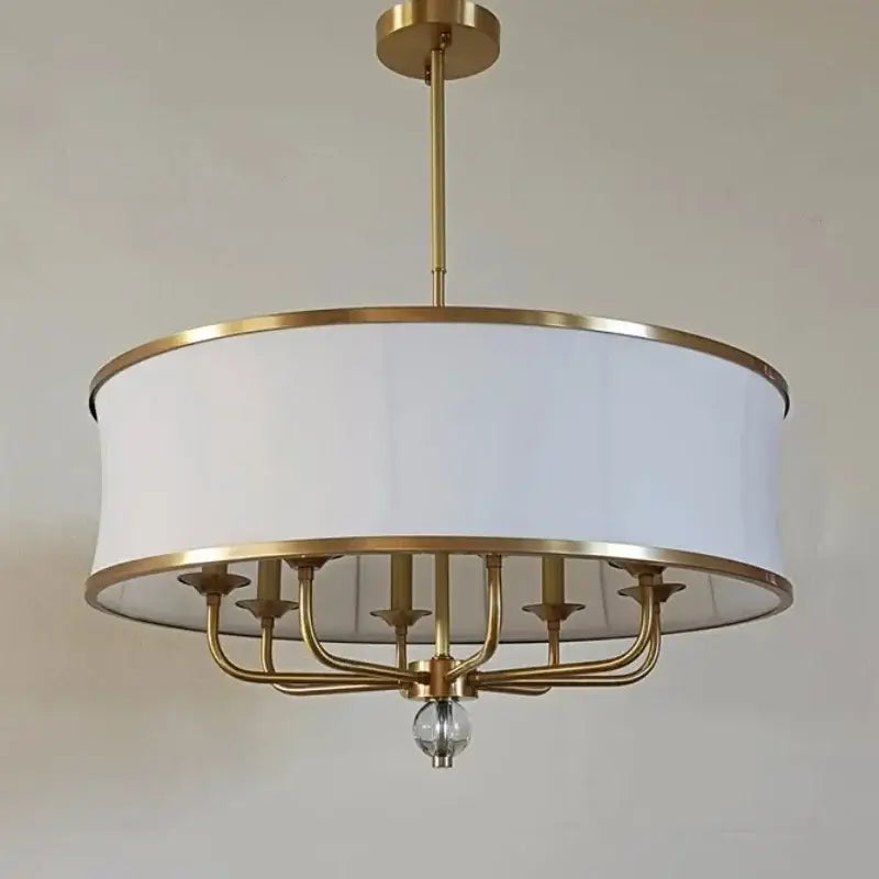 A modern decorbites gold rod led chandelier with brass finish six arms white fabric shade and central crystal pendant
