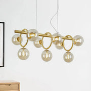 Modern gold round pendant chandelier with cognac glass spheres and circular metal rings in linear design for dining room