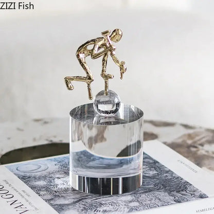 Modern gold runner crystal sculpture abstract statue featuring a gold figurine on a clear crystal sphere decorbites crystal sculpture