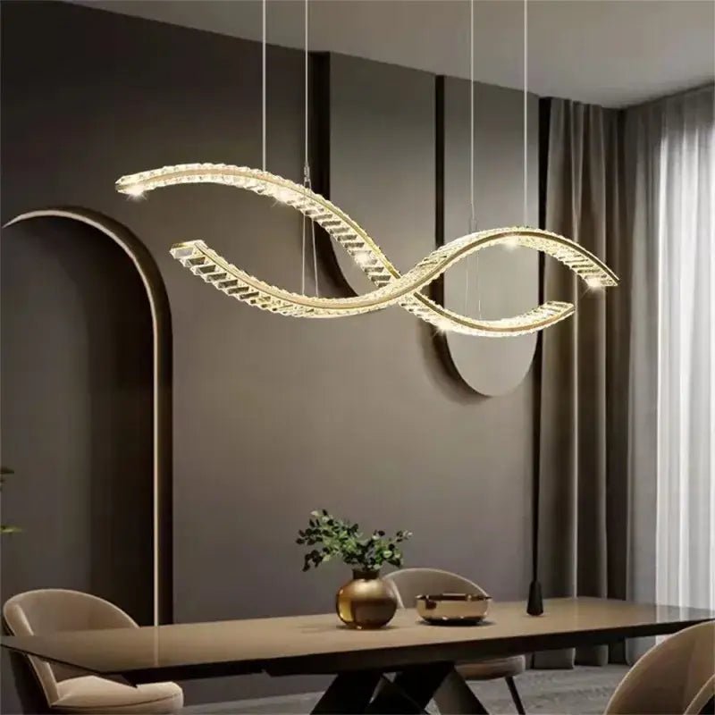 A modern gold-toned decorbites crystal led pendant with sleek intertwined s-shaped design for dining room lighting
