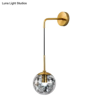 Modern gold shattered leaf clear glass globe sconce with crackled shade and black floral patterns for bedroom lighting