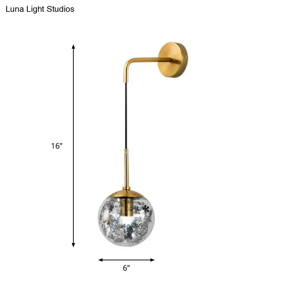 Modern gold wall sconce with clear glass shattered leaf globe and black cord light fixture for bedroom use