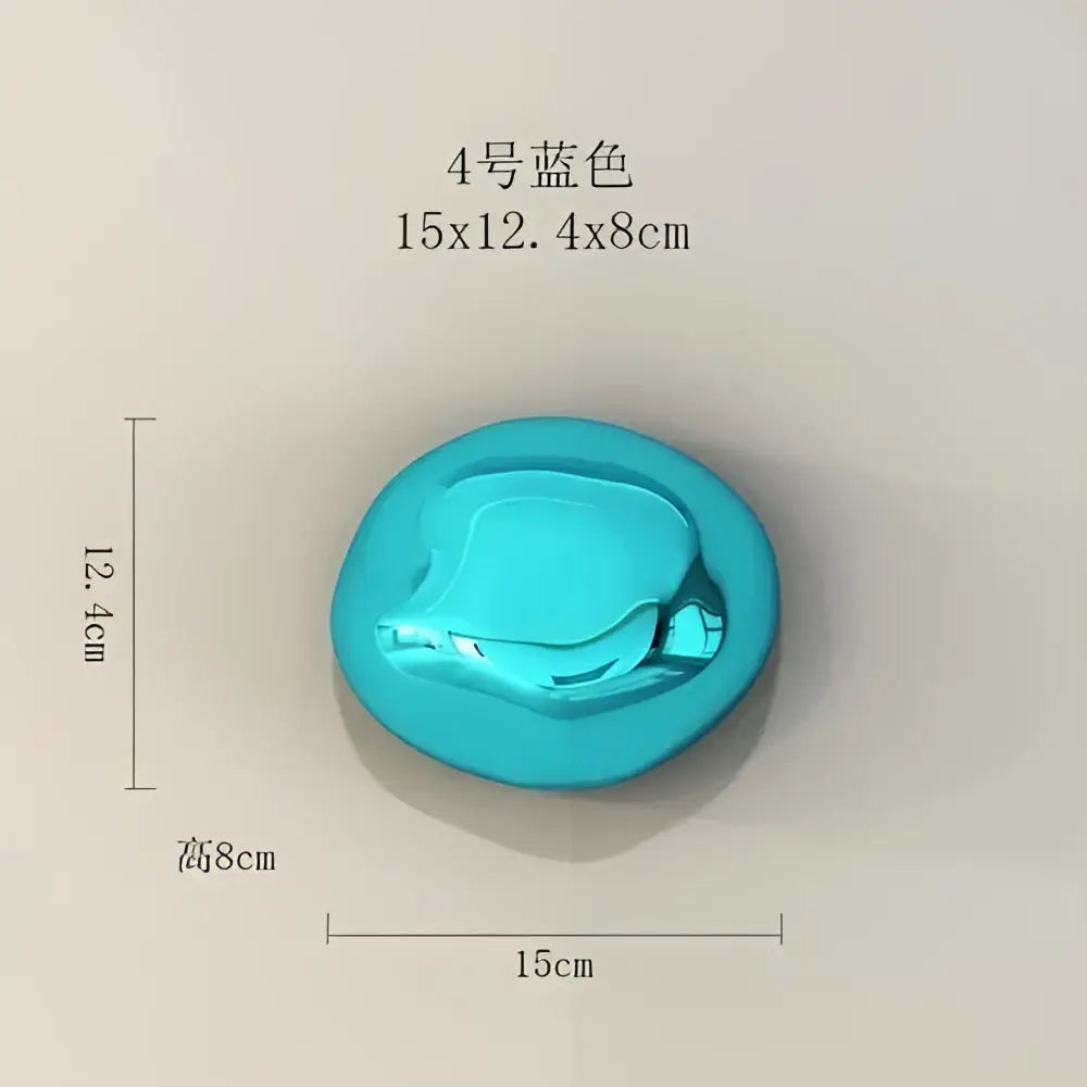 A glossy turquoise oval button with a smooth reflective surface used in modern gold and silver 3d stone wall ornaments