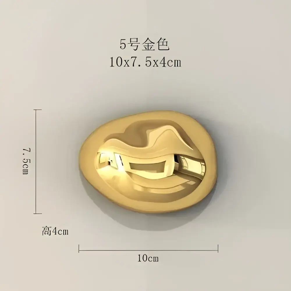 Modern gold 5-numbered metal button with a smooth oval shape and reflective surface for stone wall ornaments decor