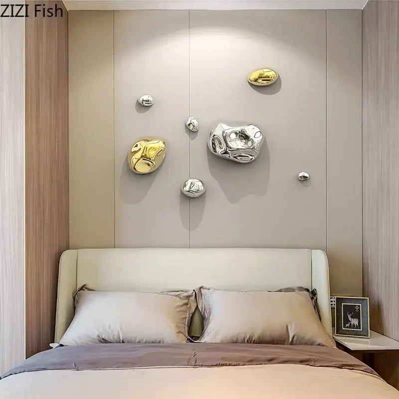 Shiny metallic stone wall ornaments in gold and silver finishes for modern living room wall decor