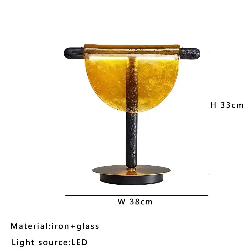 Modern gold and silver decorbites amber glass table lamp with semi-circular amber glass shade and black iron base