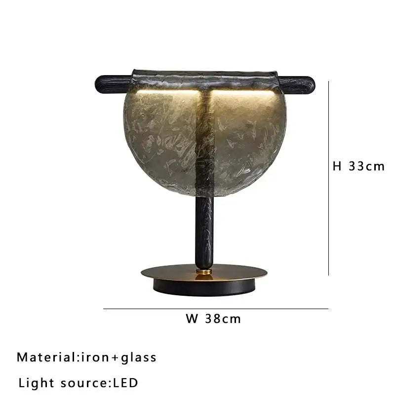 Modern gold and silver amber glass table lamp with textured translucent amber glass dome and black iron frame decorbites amber glass