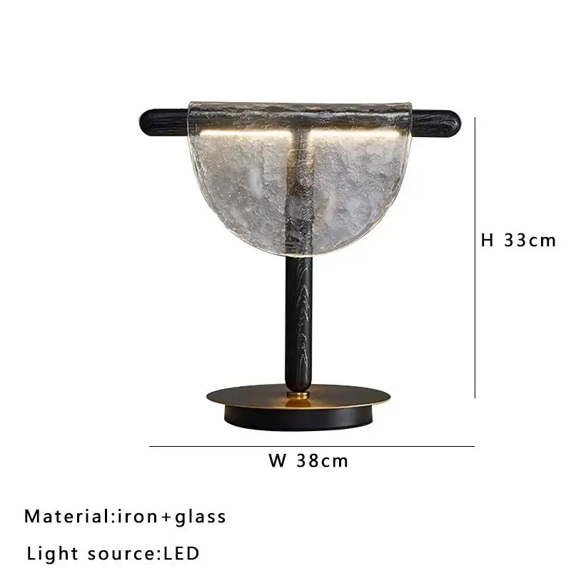 Modern gold and silver decorbites amber glass table lamp with frosted half-moon shade and black iron frame for bedroom decor