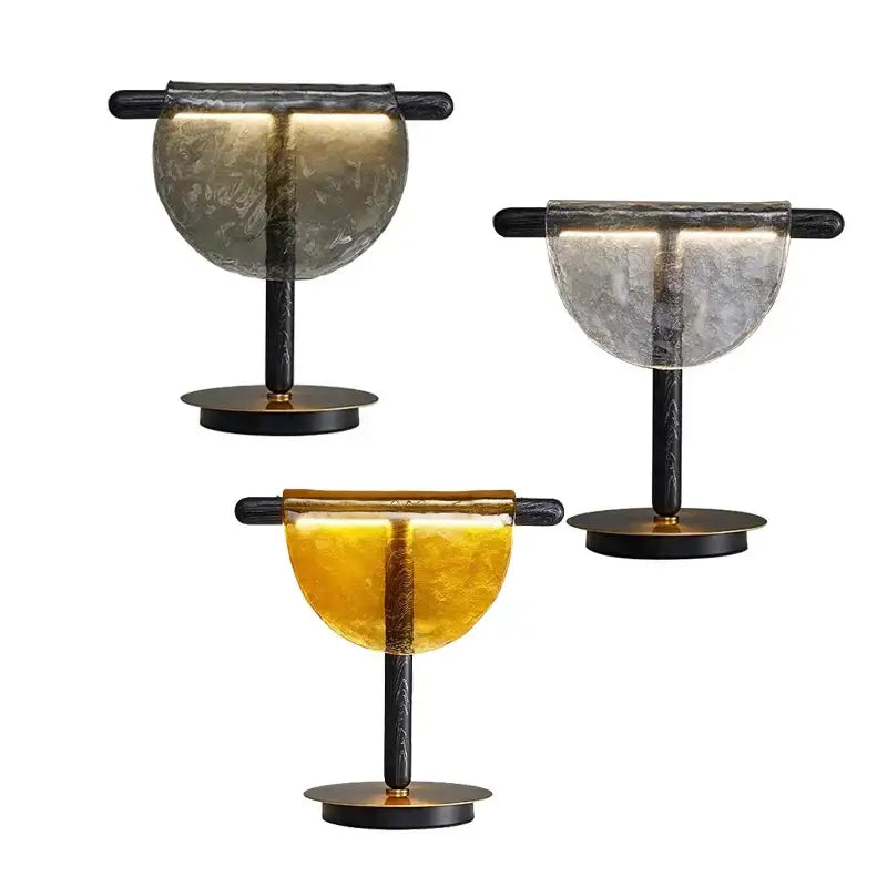 Three modern table lamps with gold and silver amber glass shades on black metal stands for bedroom decorbites decor