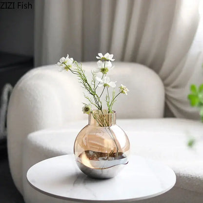 A sleek decorbites amber glass vase with a metallic base and white flowers for modern living room decor