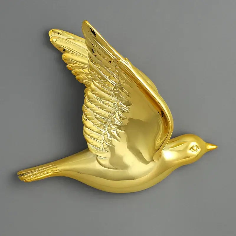 Modern gold and silver bird resin statue wall decor with detailed feathered wings and reflective finish for children’s room