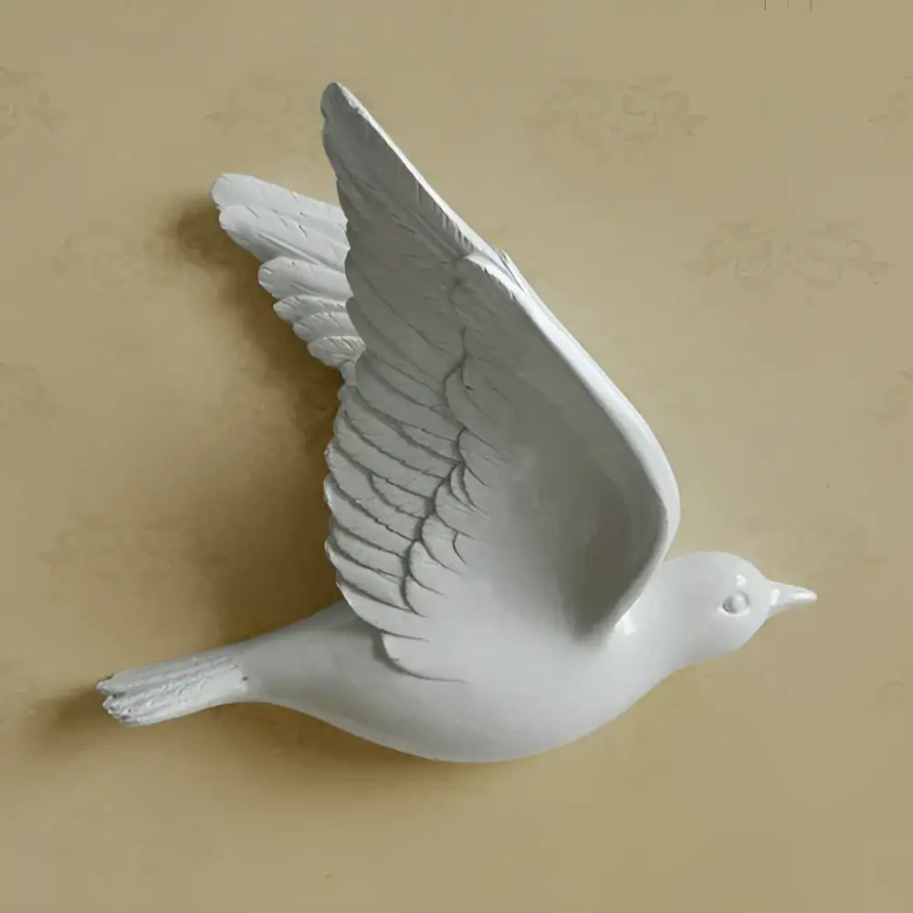 White ceramic wall-mounted bird resin statue with detailed feathers and glossy finish for modern wall decor in children’s room