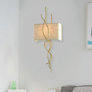 Modern gold wall mount light with gold-toned wrought iron and beige linen shade for bedroom use