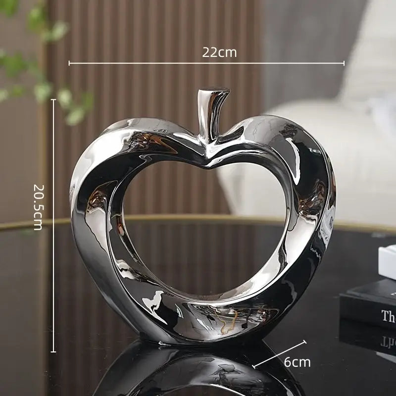 Shiny chrome heart-shaped apple sculpture in silver for modern golden apple sculpture living room decor