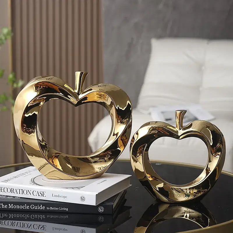 Shiny gold heart-shaped ceramic golden apple sculpture for modern living room decor displayed as apple sculpture