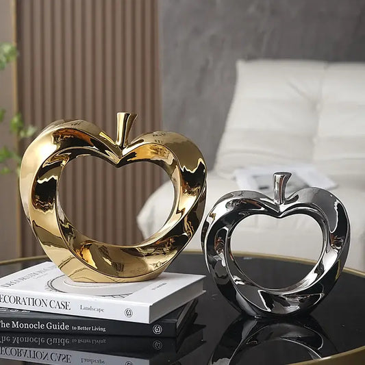 Shiny gold and silver heart-shaped ceramic golden apple sculpture with glossy finish for modern living room decor