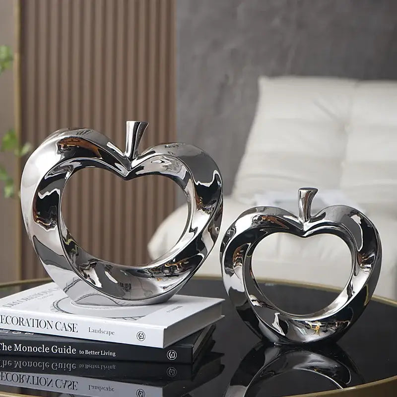Shiny chrome apple sculpture with heart cutout design modern gold and silver ceramic golden apple decor