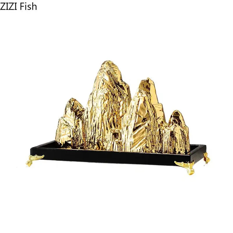 Modern gold ceramic mountain sculpture with intricate texture on black base with ornate gold feet for living room decorbites decor