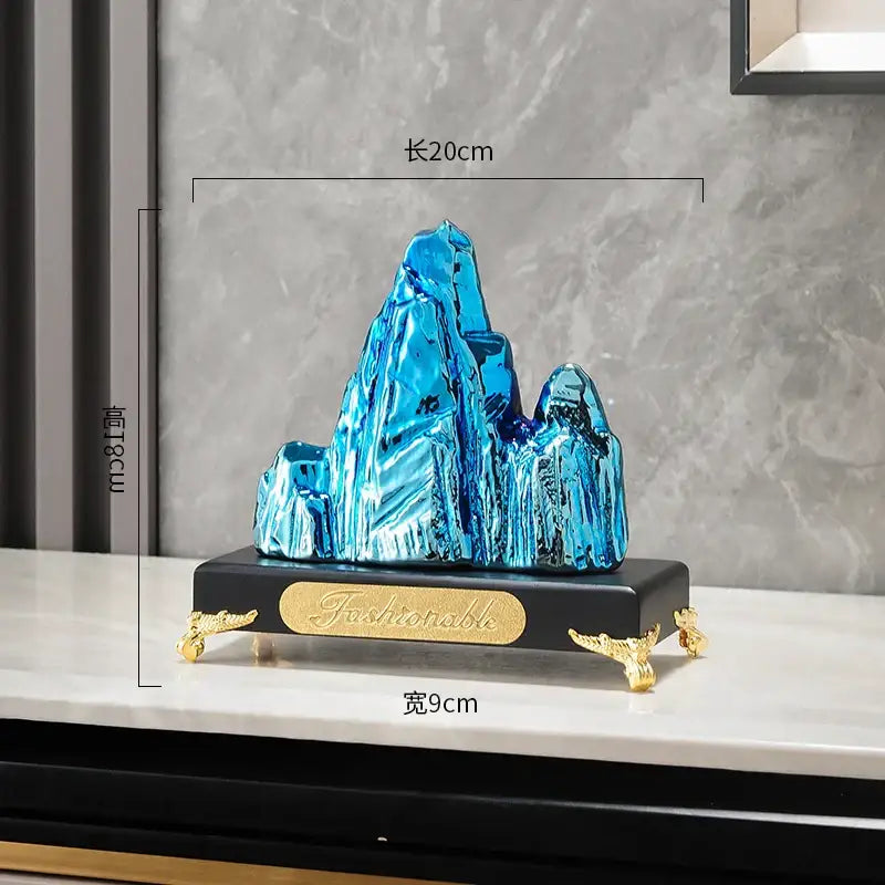 Modern gold and silver decorbites ceramic mountain sculpture with vibrant blue crystalline design and black base for living room decor