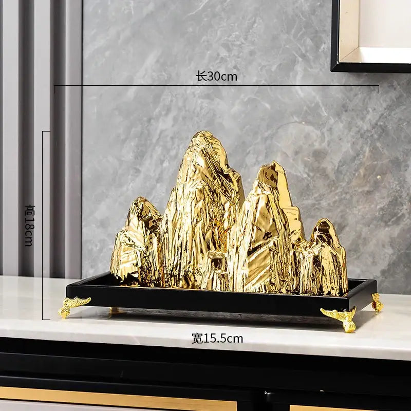 Modern gold and silver decorbites ceramic mountain sculpture with textured gold finish on black tray for living room decor