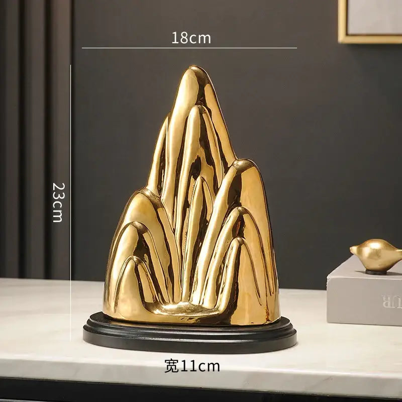 Modern gold and silver ceramic mountain sculpture with sleek abstract peaks and glossy finish for living room decorbites ceramic mountain decor