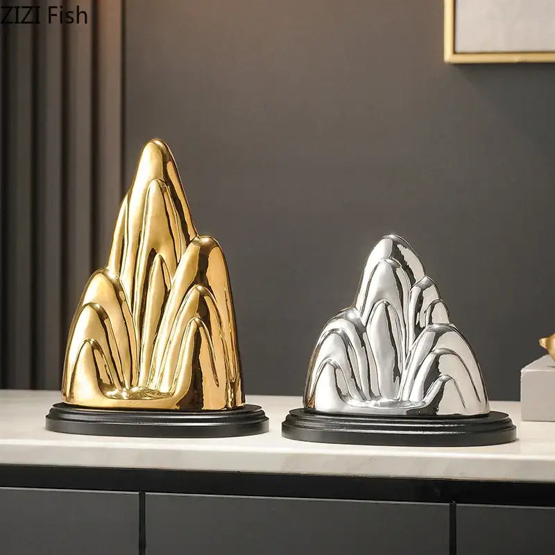 Modern gold and silver ceramic mountain sculptures with glossy finishes on black bases for living room decorbites ceramic mountain decor