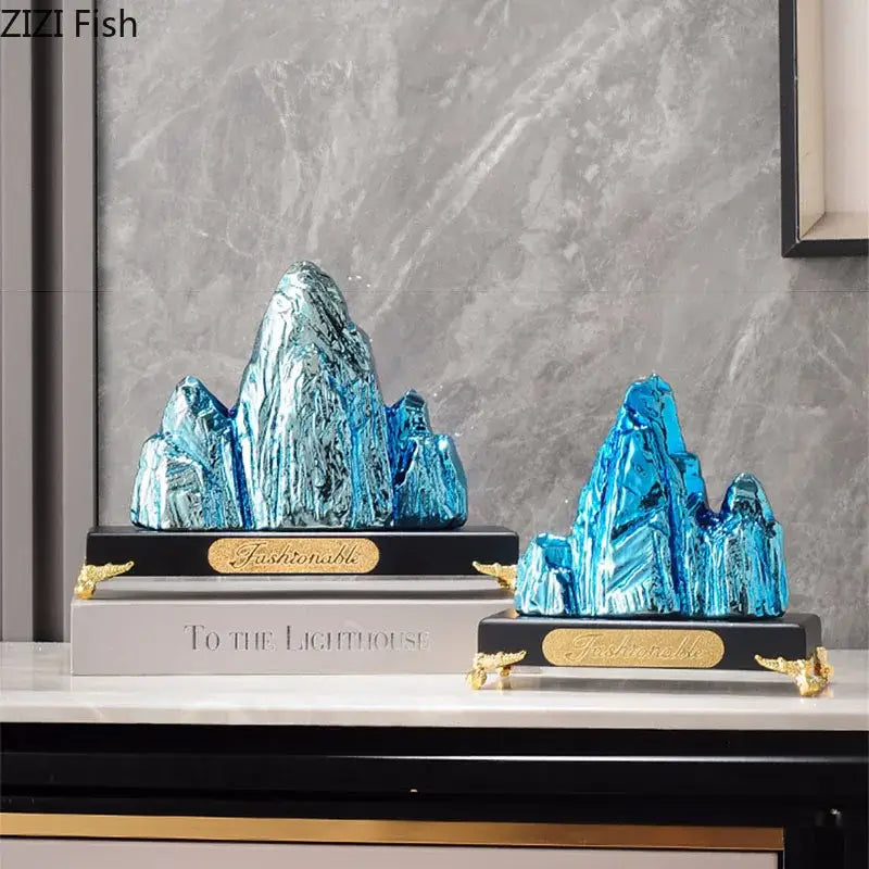 Modern gold and silver ceramic mountain sculpture decorbites with blue glass and gold accents on black bases for living room decor