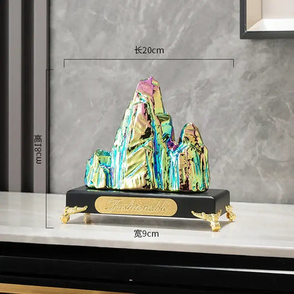 Modern gold and silver decorbites ceramic mountain sculpture with iridescent finish on ornate black base for living room decor