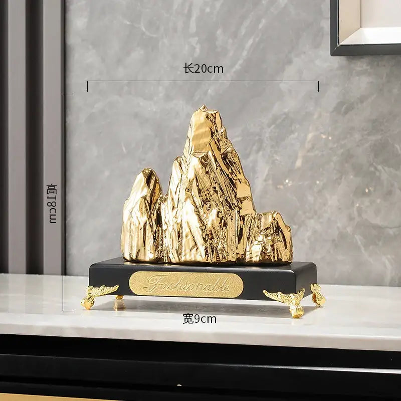 Modern gold ceramic mountain sculpture with glossy finish on black base featuring gold feet and fashionable engraving decorbites ceramic mountain